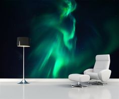 a chair and lamp in front of a wall with an aurora bore mural on it