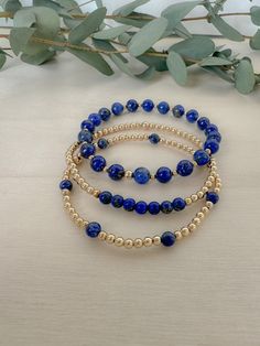 Blue lapis lazuli beaded bracelet stack | gold filled and natural lapis lazuli beads | 2.5mm- 4mm gold filled beads | 4mm- 8mm lapis lazuli beads set of three elastic beaded bracelets or select single style Lapis lazuli is a deep blue gemstone that is prized for the intensity of its color and its ability to uncover inner wisdom and truth. Lapis Lazuli Bracelet Beads, Navy Blue Beaded Bracelet, Lapiz Lazuli Bracelet, Blue And Gold Bracelets, Blue Bracelet Ideas, Gemstone Bracelets Ideas, Memory Wire Bracelets Tutorial, Bracelet Stack Gold, Pearl Jewlery