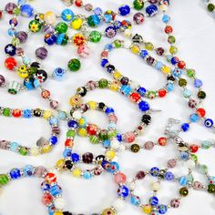 Crafted by skilled artisans in Murano, Italy, each bead of our Millefiori beaded necklace is handcrafted to perfection, creating a unique piece of jewelry. Inspired by the centuries-old Murano glassmaking tradition, these beads showcase intricate patterns and vibrant colors. The Millefiori technique involves fusing together multiple glass canes, resulting in mesmerizing floral designs that are truly one-of-a-kind. Choose from two necklaces, our large bead long necklace, or the small bead necklac Spiritual Round Beaded Necklace With Colorful Beads, Traditional Czech Glass Beaded Necklaces, Artisan Czech Glass Beaded Necklace, Artisan Czech Glass Beaded Necklace With Large Beads, Artisan Multicolor Czech Glass Beaded Necklaces, Artisan Czech Glass Round Bead Necklace, Artisan Polished Beads For Gifts, Handmade Artisan Glass Beaded Necklaces, Artisan Necklace With Czech Glass Round Beads