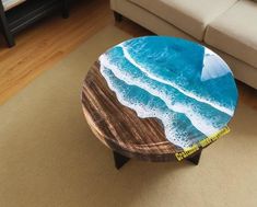 a coffee table with an ocean scene painted on it in the middle of a living room