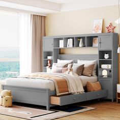 a bedroom with a bed, bookcases and rug on the floor in front of a window