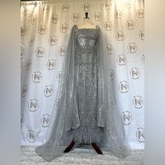 Long Feather Midi Gown Formal Floor-length Gown With Feather Trim, Luxury Feather Trim Evening Dress For Wedding, Luxury Wedding Evening Dress With Feather Trim, Luxury Evening Dress With Feather Trim, Silver Evening Gown, Red Leopard Print Dress, Gray Formal Dress, Silver Evening Gowns, Midi Gown