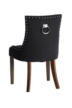 a black chair with wooden legs and studded trimmings on the backrest