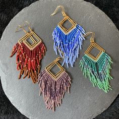 Three shade of colour seed beads woven onto a square brass finding. A nice colourful boho vibe. A great gift for your sister, wife, girlfriend... Gold plated surgical steel earring hooks are used. Please note: I've tried my best to catch the colour of the earrings but different screen settings may alter it slightly. Bohemian Rectangular Earrings With Dangling Beads, Bohemian Rectangular Beaded Earrings With Dangling Beads, Bohemian Rectangular Dangling Bead Earrings, Bohemian Multicolor Rectangular Jewelry, Bohemian Rectangular Earrings With Colorful Beads, Multicolor Bohemian Beaded Rectangular Earrings, Multicolor Square Beaded Jewelry, Multicolor Bohemian Rectangular Beaded Earrings, Bohemian Multicolor Rectangular Beaded Earrings