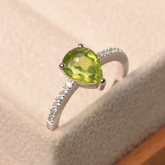 Green Teardrop Jewelry With Center Stone, Elegant Lime Green May Birthstone Ring, Green Diamond Pear-shaped Ring, Green Pear-shaped Promise Ring, Elegant Pear-shaped Green Rings, Green Teardrop Diamond Ring, Elegant Lime Green Birthstone Promise Ring, Green Pear-shaped Promise Ring Jewelry, Green Teardrop-shaped Promise Ring