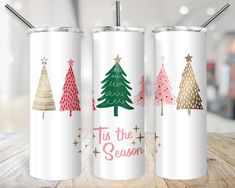 three christmas trees on white tumblers with the words tis the season