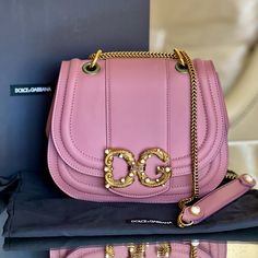 Dolce & Gabbana Amore Bag - New With Box, Authenticity Card, Dust Bag And Protective Foil - Color: Pink Powder - Size: 9”L X 7.1”H X 3.1”W - Shoulder Chain Strap Drop: 21” - Amore D&G Buckle At Front - Push Lock Closure - Internal Pocket With Zipper - Calf Leather - Can Be Worn Long, Short Or Cross Body Reasonable Offers Only Please! Dolce And Gabbana Pink Bag, High-end Pink Shoulder Bag For Evening, Luxury Pink Bags As Gifts, Luxury Pink Bags For Gifts, Luxury Shoulder Bag With Detachable Strap As Gift, Luxury Shoulder Bag With Dust Bag For Gift, Luxury Pink Shoulder Bag For Evening, Designer Pink Shoulder Bag For Evening, Pink Dolce And Gabbana