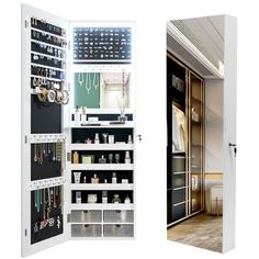 an open closet with jewelry on the shelves and door to another room in front of it