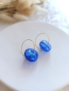 "Add a touch of elegance to your everyday look with these Contemporary Handmade Earrings. Crafted with precision, these exquisite earrings showcase stunning Striking Blue Glass Blown Jewelry, guaranteed to turn heads wherever you go. The vibrant blue hue captures the essence of sophistication, while the sleek stainless steel hoop adds a modern twist. Handmade with love and care, these earrings offer a unique blend of style and craftsmanship. Whether you're dressing up for a special occasion or simply want to elevate your daily attire, these earrings are the perfect accessory to make a bold and fashionable statement. Ships from a small business in Spain Charms: The glass bead is hollow blown bead of striking blue glass . Gold Hoop diameter: 25 mm (1 inches) Earring total length: 40 mm (1.6 Blue Hypoallergenic Hoop Earrings, Blue Hoop Earrings With Ear Wire, Blue Small Hoop Earrings For Pierced Ears, Blue Small Hoop Earrings With Matching Set, Blue Hypoallergenic Small Hoop Earrings, Handmade Blue Round Hoop Earrings, Blue Hoop Earrings For Gift, Blue Hoop Earrings For Everyday, Blue Round Earrings For Pierced Ears