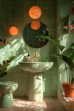 a bathroom with green tiles and potted plants in the corner, along with a white pedestal sink