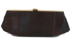 "Midcentury clutch. With my research, I believe this to be a good faux alligator handbag. It has a brass look frame , brown cloth interior with no maker's label. Closure is secure. Overall in good-very good condition. I conditioned it and it is ready for an forever home. Very usable and displayable. Measures: 12\" wide, 5\" high including clasp, 1\" deep. (R)"