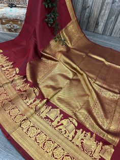 Gorgeous maroon pure silk handloom saree with grand gold zari bridal brigade "baraat"  woven border. -Pure Kanchipuram silk saree authenticated by Silk Mark Certificate.  -Blouse fabric included. -Fall attached. Note:  - Slight inconsistency in weaving is inherent to handloom sarees and is not a defect. -The color of the products may slightly vary according to the ambient lighting conditions and the color calibration of LED devices. If you would like more clarity before your purchase, please drop us a message . Red Kanchipuram Saree Bride, Kanchipuram Silk Saree Wedding Latest, South Indian Blouse Designs, Maroon Saree, Blouse Designs Indian, Indian Blouse, Kanjivaram Sarees, Kanchipuram Saree, Pure Silk Sarees