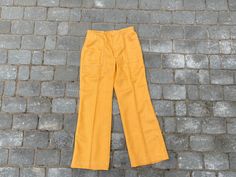 "Vintage 70s Soviet women wool pants, unused yellow orange colour winter pants. 2 pockets front side. Closes with zipper and hook. Size - no size tag, custom made. ♥ Measurements (lying flat) - WAIST 35CM ♥ Total length- 101 cm (39.76) ♥ Waist - 35cm (13.77) ♥ Hips - 49cm (19.29\") ♥ Inseam - 75cm (29.52) ♥ Rise - 27cm (10.62\") WAIST 38.5CM ♥ Total length- 99cm (38.97\") ♥ Waist - 38,5cm (15.15\") ♥ Hips - 54cm (21.25\") ♥ Inseam - 76cm (29.92) ♥ Rise - 26cm (10.23\") ♥ Materials - wool ♥ It is Pants Custom, 70s Women, Jaune Orange, Wool Mittens, Winter Pants, Vintage Soviet, Wool Pants, Estonia, Orange Yellow