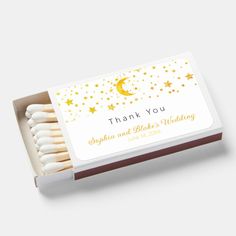 thank you matchbox with matches in it and gold stars on the top, along with a white box containing matches