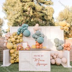 an outdoor dessert table with balloons on the wall and sign that says you're my dream space