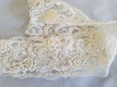 Beaded lace trim with pearls and sequins. Ivory cream beautifully beaded.  Great for invitation cards, candles, votives.  Hand stitched faux pearls and sequins.  Elegant good quality trim and great for bridal veils and ring cushions. Also available in White and Black. Measurement:  8 cm / 3 inches  Listing 1 X Yard of Beaded Lace Trim Ivory  If you require more than the 1 yard listed let me know and I will organise a special listing for you.  I will refund postage in excess of $1.00 Cream Lace Bridal Accessories For Party, Elegant Cream Lace For Mother Of The Bride, Cream Lace With Pearl Embroidery For Wedding, Cream Wedding Lace With Pearl Embroidery, Elegant Cream Lace For Bride, Cream Bridal Accessories For Mother Of The Bride, Cream Beaded Bridal Accessories For Wedding, Elegant Beaded Lace For Wedding, Cream Lace Bridal Accessories For Wedding