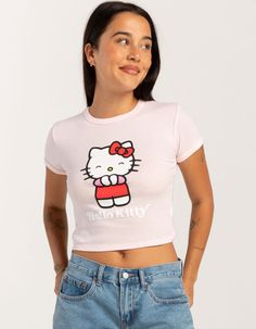 Sanrio Hello Kitty Happy Baby Tee. Large Graphic Screened On Front. Ribbed Crew Neckline. Short Sleeve. Shrunken Fit. 50% Cotton, 50% Polyester. Machine Wash. Imported. Model Is Wearing A Size Small. Model Measurements:height: 5'7" Bust: 34"waist: 25"hips: 34.5" Pink Hello Kitty Cotton Top, Hello Kitty Short Sleeve Top, Kawaii Hello Kitty Print Crew Neck Top, Hello Kitty Crew Neck Fun Tops, Fitted Hello Kitty Tops, Playful Hello Kitty Tops For Spring, Spring Hello Kitty Playful Tops, Cute Fitted Tops With Cartoon Print, Trendy Pink Top With Cat Print