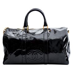 A classic Bowler bag made in the bold and statement black patent leather, this Chanel bag is everything that is highly functional and also extremely stylish. With a gold-tone top zipper closure and a classic bowler shape, this bag provides ample storage space for all your belongings. Featuring dual rolled top handles, a detachable shoulder trap, a gold CC charm, an embellished CC logo on the front, top zip closure and black woven fabric interior lining. Chanel bags with the code 4xxxxxx are manu Designer Black Bags With Glossy Finish, Luxury Black Patent Leather Bag, Classic Black Bag With Glossy Finish, Classic Black Bags With Glossy Finish, Black Glossy Business Bag, Black Glossy Travel Bags, Chic Black Patent Leather Bag, Classic Glossy Travel Bag, Classic Patent Leather Bag With Glossy Finish