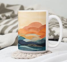 a coffee mug sitting on top of a bed