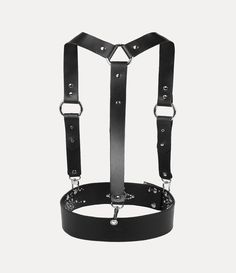 The iconic Studs harness has been revived this season. This reinterpretation for our new collection receives intricate stud detailing with industrial-style straps, complete with an orb at the front of the strap - evoking Vivienne's vision of taking tradition into the future. Gothic Leather Harness With Belt, Black Gothic Leather Harness, Black Leather Punk Harness, Adjustable Leather Harness With Belt, Black Party Harness With Belt Loops, Party Harness With Belt Loops In Black, Leather Strapped Harness, Leather Harness With Straps, Black Leather Harness With Adjustable Strap