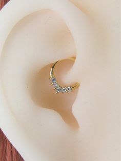 a close up view of a gold ring with diamonds in it on a white plate