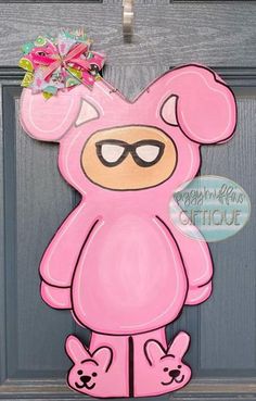 a pink bear door hanger with sunglasses on it's head and two ears