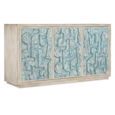 an image of a blue and white cabinet with carvings on the front, side view