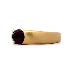 This versatile modern ring is perfect as the centerpiece of a stack or on its own. Crafted from 18 karat yellow gold, the ring features an oval cut garnet gemstone. The gemstone is flush set, with a weight of .95 carats. The brushed gold detailing adds a subtle texture and enhances the beauty of the garnet. Metal Shop, Modern Ring, Shop Engagement Rings, Subtle Textures, Garnet Gemstone, Stacking Ring, Gold Details, Stacking Rings, Yellow Gold Rings