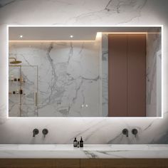 a bathroom with marble counter top and large mirror