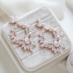 These large cluster style hoop statement earrings catch the light in a truly romantic and glamorous way! Perfect for brides who really want to shine on their special day!- Handcrafted with Premium cubic zirconia stones- All clear stones- Available in rose gold, yellow gold, and rhodium (silver) finishes- Earrings measu Glamorous Crystal Hoop Earrings For Wedding, Sparkling Hoop Jewelry For Wedding, Silver Hoop Earrings With Sparkling Stones For Wedding, Dazzling Halo Design Bridal Earrings For Party, Glamorous Hoop Wedding Jewelry, Dazzling Hoop Earrings For Wedding, Glamorous Hoop Jewelry For Wedding, Dazzling Crystal Hoop Earrings For Wedding, Elegant Hoop Chandelier Earrings For Wedding