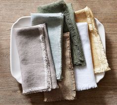 five different colored towels on a white plate