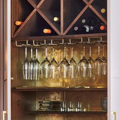 wine glasses are lined up on the shelves