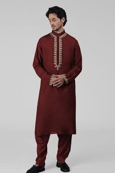 Maroon kurta featuring intricate tilla embroidery and delicate gold thread work on the front placket, sleeves, and neckline. Paired with a pathani salwar.
Components: 2
Pattern: Embroidered
Type Of Work: Tilla
Neckline: Band collar
Sleeve Type: Long
Fabric: Silk
Color: Maroon
Other Details: 
Attached lining
Length:
Kurta: 47 inches
Sleeve: 27 inches
Placket: 15.5 inches
Salwar: 42 inches
Occasion: Mehendi and Puja - Aza Fashions Pathani Salwar, Tilla Embroidery, Types Of Work, Gold Thread, Band Collar, Fabric Silk, Thread Work, Gold Threads, Embroidered Silk