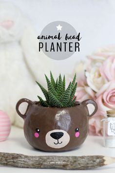 a brown bear planter sitting on top of a table