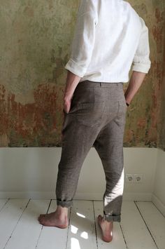 "Linen drop-crotch pants for men are a part of your casual outfit or any specific occasion. A loose cut around the thigh with a narrow shape through the leg feels very comfortable even during the hottest days. The above ankle length of the pants looks good with sandals as well as sneakers. These stylish pleated pants have four pockets - one at each side and two in the back. You will be beloved to wear them! DETAILS: - OEKO-TEX certified product (Sustainable Textile) - Zip fly with two buttons cl Bohemian Brown Relaxed Fit Bottoms, Bohemian Bottoms With Relaxed Fit And Tapered Leg, Brown Relaxed Fit Straight Leg Harem Pants, Brown Relaxed Fit Harem Pants, Fitted Linen Bohemian Bottoms, Fitted Bohemian Linen Bottoms, Linen Pants For Men, Linen Pants Men, Linen Trousers Men