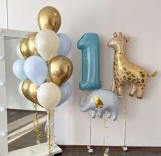 some balloons and giraffes are in front of a mirror