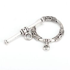 a silver charm with a key hanging from it's end on a white background