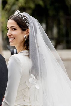 the bride smiles as she walks down the aisle