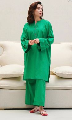 An emerald ensemble showcasing a contemporary silhouette, ideal for daily wear Color: Emerald Fabric: Lawn Cut: boxy Trouser: Lawn Culotte Solid Suit Designs, Plain Pakistani Suits Simple, Stylish Cord Set Designs, Plain Cord Set Design, Winter Outfits Pakistani Casual, Pakistani Coord Sets, Winter Pakistani Suits, Green Winter Outfits, Trending Suit Designs