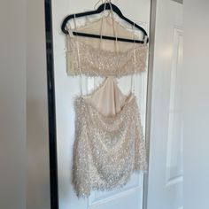 a dress hanging on a hanger in front of a door