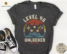 IMPORTANT - CUTOFF TIME FOR CHRISTMAS ORDER IS 11TH DECEMBER, AFTER 11TH DECEMBER WE RECOMMEND EXPRESS SHIPPING OPTION WHICH CAN BE AVAILED TILL 17TH DECEMBER TO ARRIVE IN TIME FOR CHRISTMAS 45th Birthday T Shirt, Level Unlocked Shirt, Hello 45th Birthday Shirt for Men, 45th Birthday Gift, 45th Birthday Gamer Shirt, Gaming Gift I! Welcome to my store, It's really nice to see you here. Good news! 🎉 You're one step closer to touch somebody's life who you never met and make it's dreams come true! This is a real small business with high hopes and irrepressible goals. --- This is a spectacular Birthday Gift for Gamer Husband, Wife, Son and Daughter, This Retro Video Game Shirt is Funny 45 Year Birthday Gift For Husband, Wife, Son and Daughter from whole family, This Video Game Shirt is best gi 50th Birthday Shirts Men, 50th Birthday Games, Father Son Outfits, 45th Birthday Gifts, Dad And Son Shirts, Video Game Shirt, Gift For Gamer, Son And Daughter, 50th Birthday Shirts