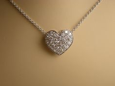 "This pave diamond heart pendent is 11.6 mm long and 12.6 mm wide. The 26 diamonds clarity is VS and G-H color and the total weight is .51 cts. Pendent and chain are 18k white gold total weight is approximately 3.2 grams. The 18k white gold chain is made in Italy and can be 16, 17 or 18 inch long. We love these pendent because it represents the way jewelry should be made with craftsmanship and quality. This pendent is anything but ordinary. Our pieces are designed and made with craftsmanship and Gold Diamond Necklace In Platinum For Anniversary, Gold Platinum Diamond Necklace For Anniversary, Valentine's Day Formal Diamond Necklace With Pave Setting, Luxury Platinum Jewelry For Valentine's Day, Heart Shaped Jewelry With Pave Setting For Formal Occasions, Luxury Heart Pendant Jewelry With Pave Setting, Gold Platinum Necklace Gift, Luxury Pave Setting Necklace For Valentine's Day, Hallmarked Platinum Diamond Necklace As Gift