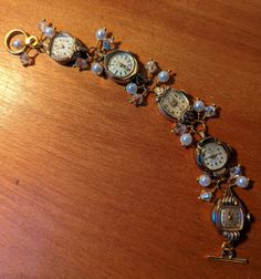 "FUN! This is a bracelet made from vintage watches dating from the 1930s and up. There are a variety of watches used; this one includes Helzberg 10k RGP, Benrus 10k RGP, Devon 10k RGP and Bulova 10k RGP. I just love the different shapes of the watches! I've used faux pearls and clear crystals in this bracelet.  The bracelet measures about 1/2\" wide and 7.25\" long but can be shortened or lengthened to your specifications, simply send me a message. Each of my pieces are one of a kind, unique pie Jewelry Made From Old Watches, Luxury Vintage Handmade Watch Accessories, Vintage Bracelet Watch, Repurposed Watches, Button Choker, Victorian Steampunk Wedding, Unique Pies, Watch Bracelets, Watch Art