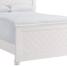 a white bed with an upholstered headboard and foot board on the side