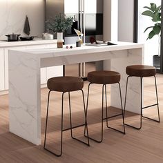 three stools are sitting at the counter in this modern kitchen