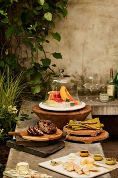 a table topped with lots of different types of cheeses and pastries on plates