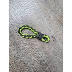 a yellow and black rope on top of a wooden floor next to a bottle opener