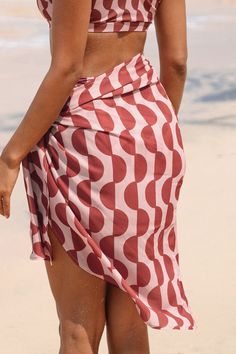 Add a touch of tropical charm to your beach look with our Coral GEO Knotted Sarong. Crafted with vibrant coral hues and featuring a stylish knotted design, it effortlessly elevates your seaside ensemble. Product code: CAA07D4D007JD Features:  Woven Knotted Midi Material: 100%POLYESTER. Pink Summer Sarong For Vacation, Pink Sarong For Summer Beach Cover-up, Beachy Sarong For Vacation, Casual Beach Cover-up With Tie-side Bottom, Lightweight Beachy Swimwear For Beach Season, Lightweight Beachy Swimwear For Summer, Spring Vacation Tie-side Sarong, Casual Sarong For Poolside And Beach Season, Lightweight Beach Swimwear For Summer