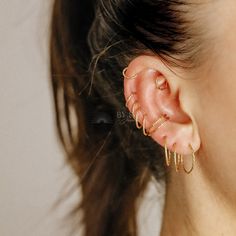 a close up of a person with ear piercings