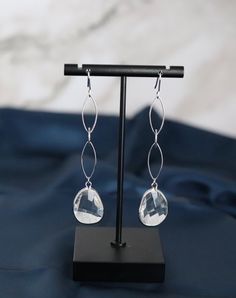 These Silver Teardrop Dangling Earrings are a must-have for any fashionista. They're made of glass and are lead and nickel free. They're 3 1/4" long and 5/8" wide. They have a classic teardrop shape that will flatter any face shape. The earrings are perfect for any occasion, from a casual day at the office to a night out on the town. Day At The Office, Dangling Earrings, Jewelry Inspo, Face Shape, Christmas Sale, Face Shapes, Wind Chimes, Rainbow Colors, The Office